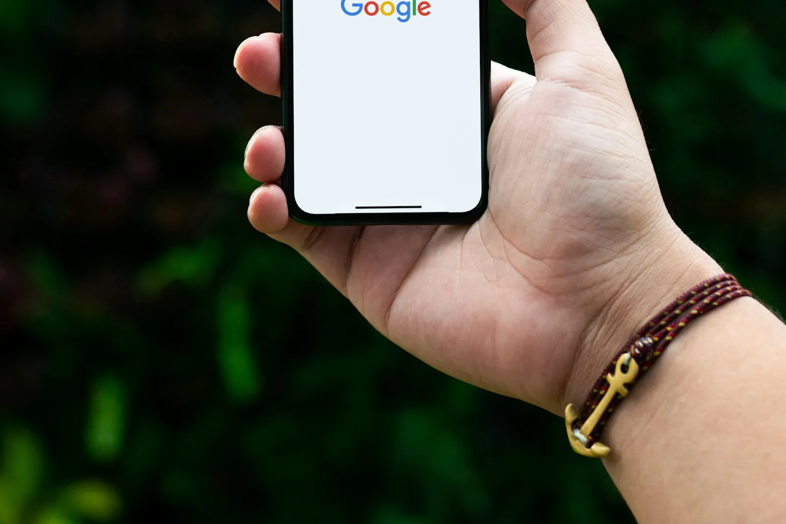 Hand holding a smartphone with a search app open, illustrating how much mobile data you need in Korea