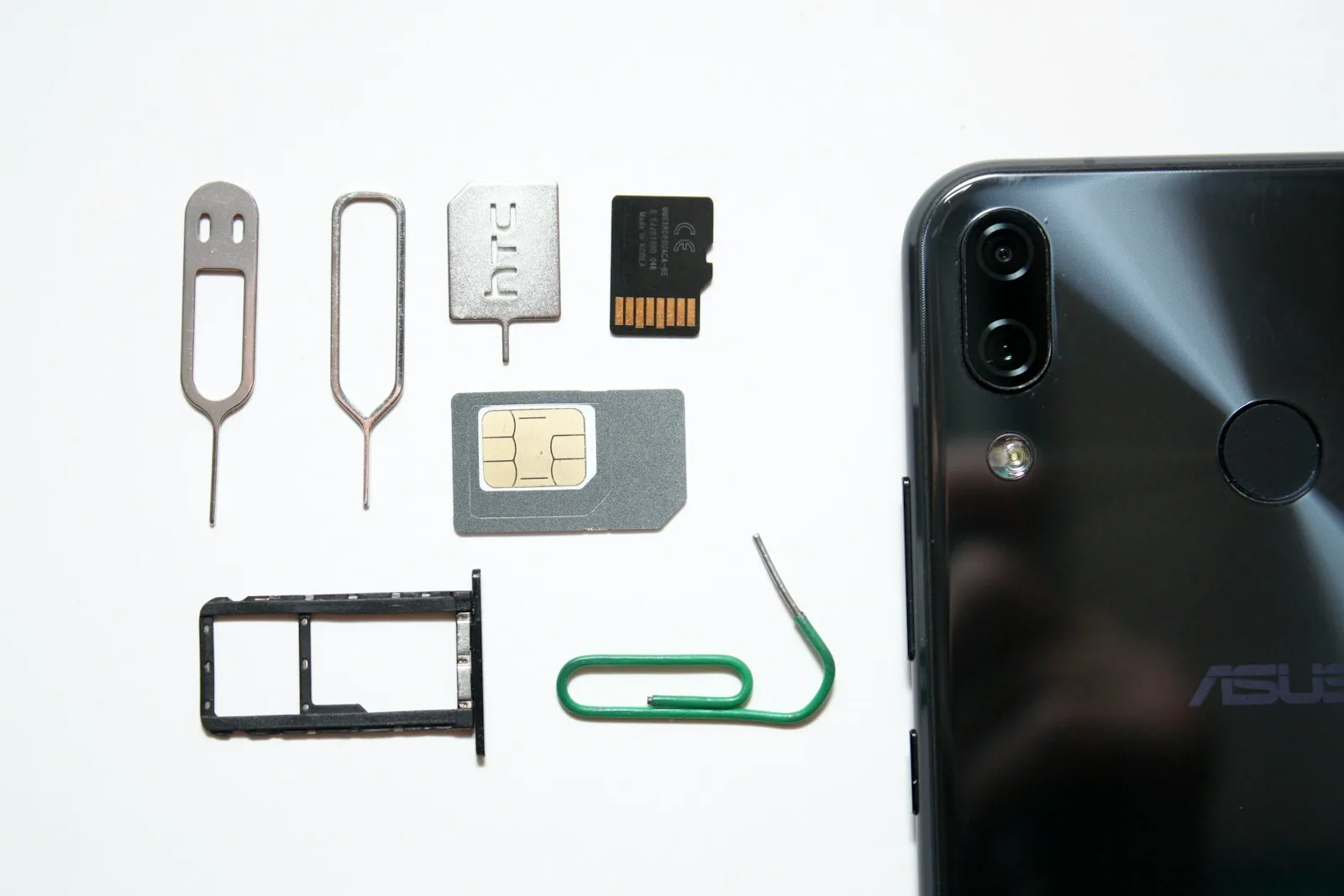 Korea eSIM activation — nano-SIM, SIM tray and eject pin beside a smartphone ready for setup