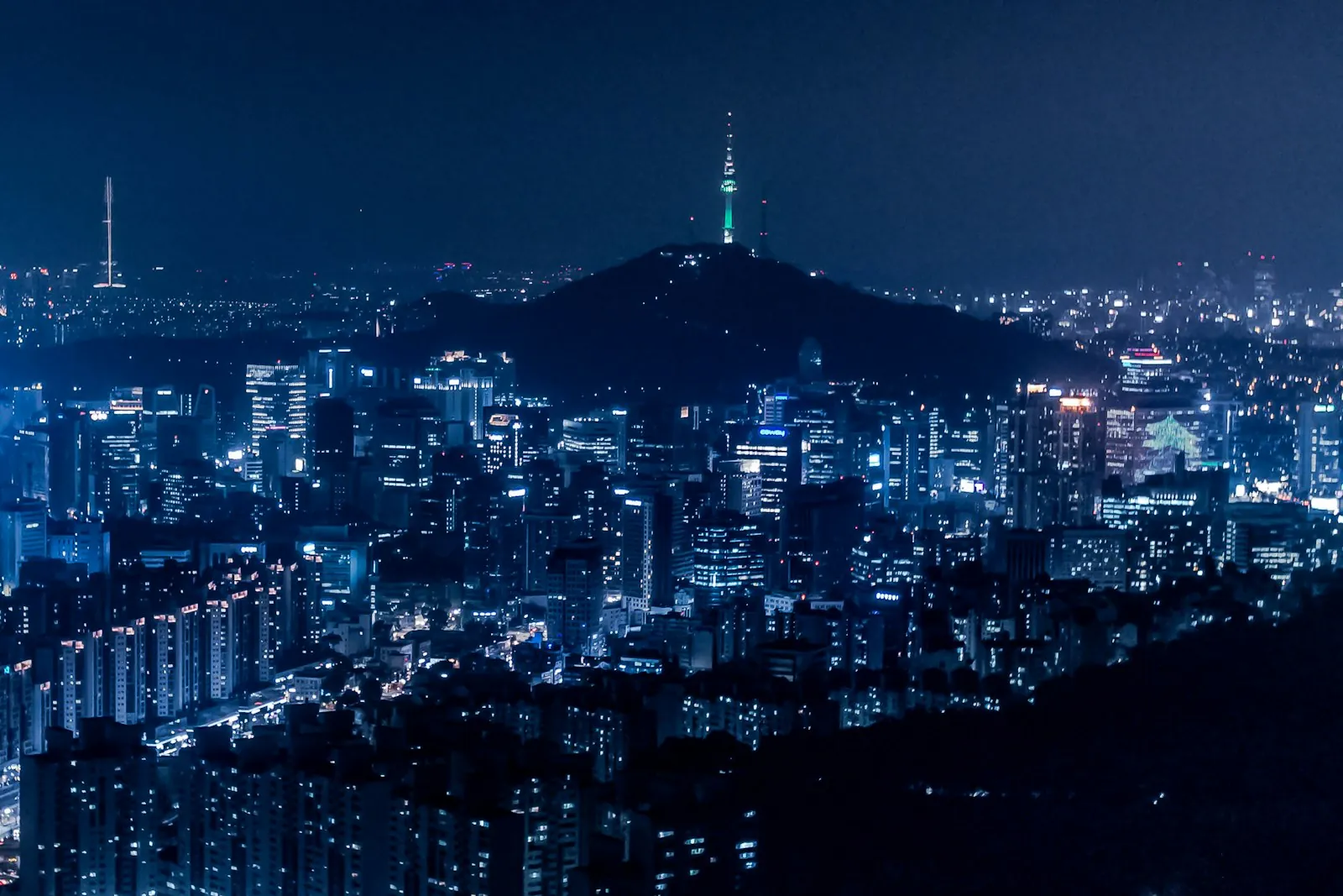 Seoul city skyline at night with N Seoul Tower, illustrating a Korea eSIM comparison of Kimchi Mobile versus Saily, Airalo and Holafly