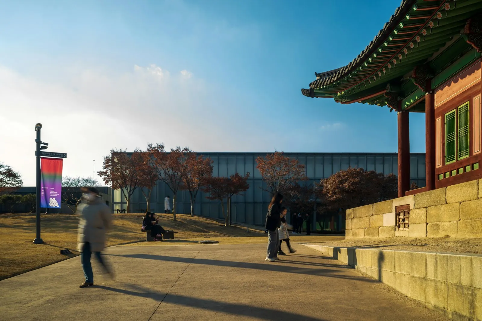 Students walking on a Korean university campus at golden hour, illustrating a Korea SIM and eSIM setup for D-2 international students